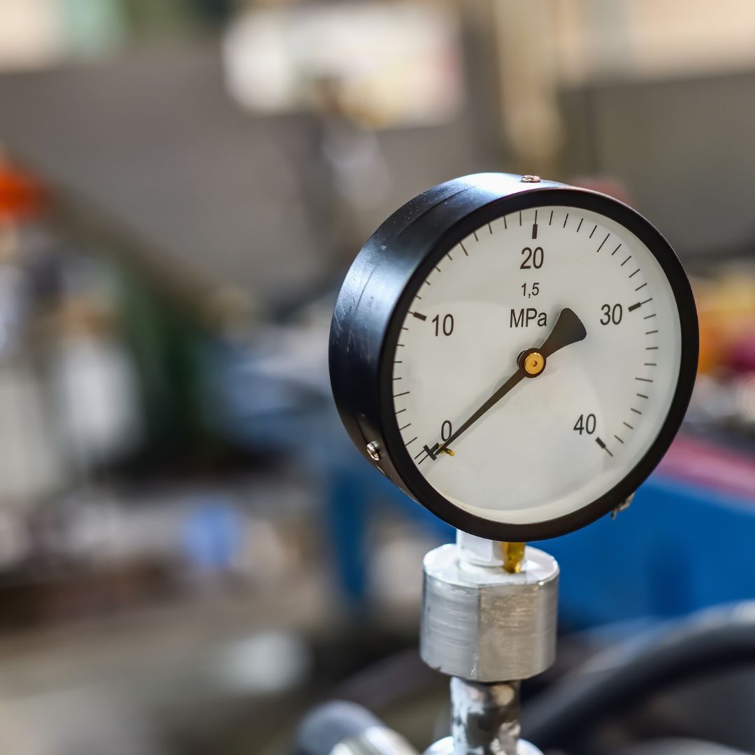 Manômetro industrial de alta pressão indicando medição em MPa durante teste de qualidade em fábrica. Símbolo do rigor técnico da Master Hidráulica.